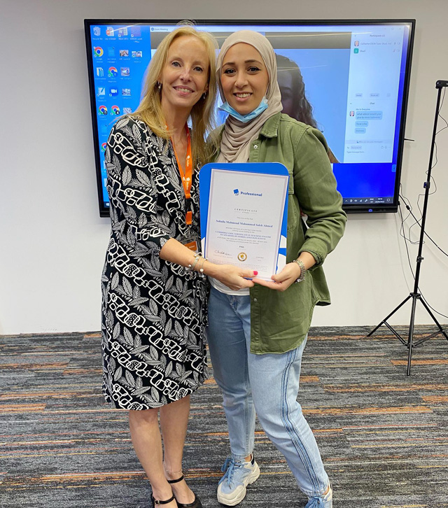 Catharine giving certificate to a TESOL graduate.